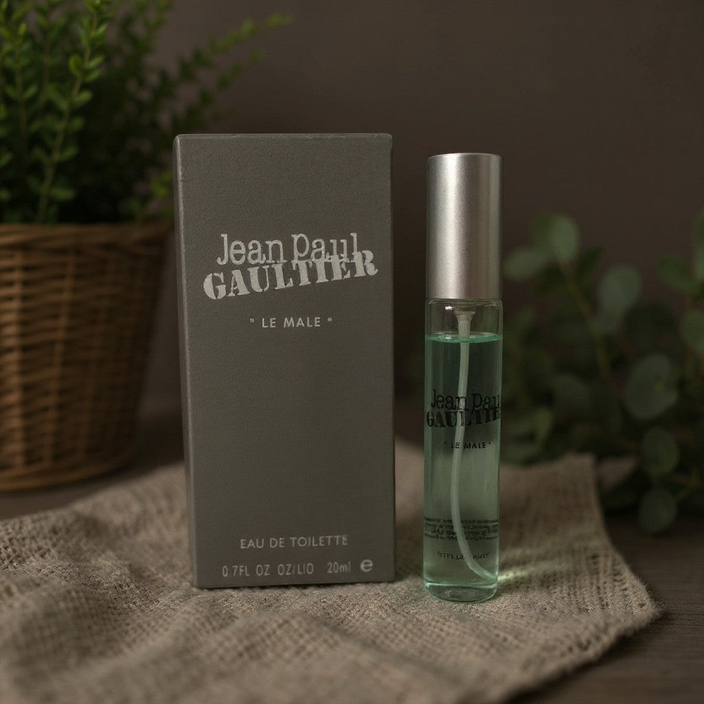 LUXAZON Jean Paul Gaultier Le Male Eau de Toilette 0.7 fl oz spray bottle with grey box on a textured cloth surface