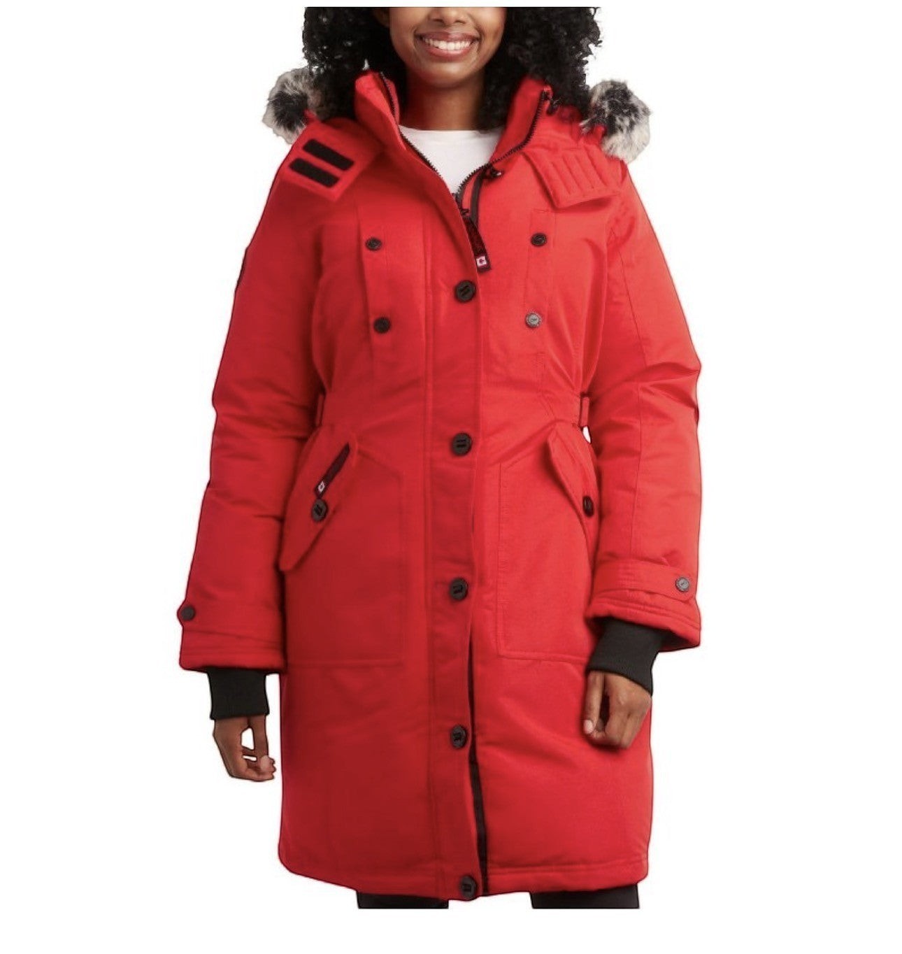 A woman wearing a bright red LUXAZON heavyweight puffer parka with a detachable faux-fur hood and secure pockets.