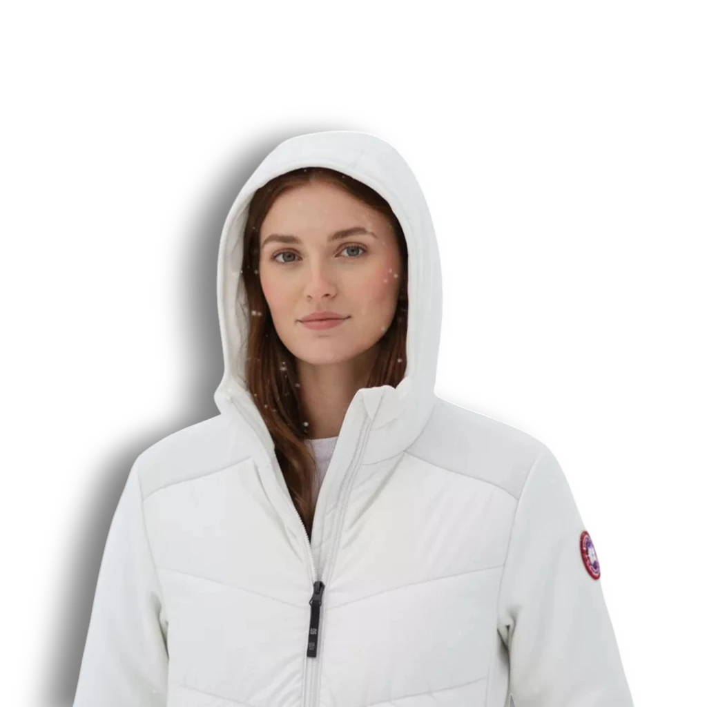 A woman wearing a white LUXAZON lightweight insulated hooded jacket with a quilted front in a snowy outdoor setting.